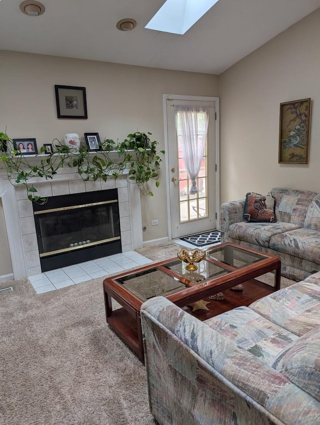 1209 Kensington Unit 1209, Mundelein, IL 60060 - living room featuring a skylight, carpet, and a tiled fireplace