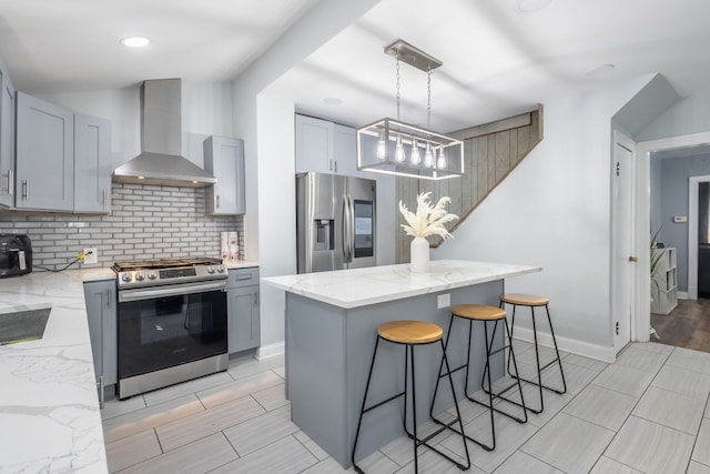 5648 S California Ave, Chicago, IL 60629 - kitchen featuring wall chimney range hood, stainless steel appliances, a chandelier, gray cabinetry, and decorative backsplash