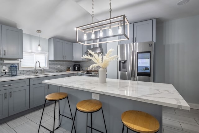 5648 S California Ave, Chicago, IL 60629 - kitchen featuring stainless steel fridge with ice dispenser, a sink, decorative backsplash, and gray cabinets