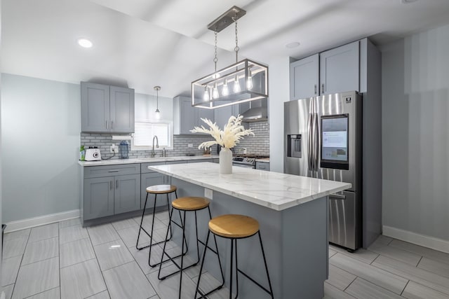 5648 S California Ave, Chicago, IL 60629 - kitchen with stainless steel refrigerator with ice dispenser, a sink, backsplash, a kitchen breakfast bar, and recessed lighting