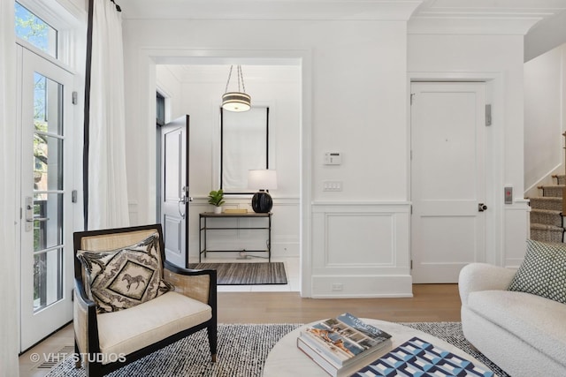 1963 N Dayton St, Chicago, IL 60614 - living area with stairway, wood finished floors, a decorative wall, and wainscoting