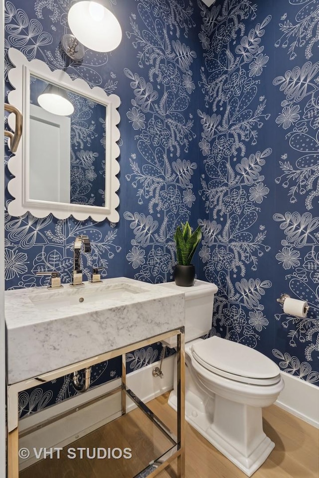 1963 N Dayton St, Chicago, IL 60614 - half bathroom featuring toilet, vanity, wallpapered walls, and wood finished floors
