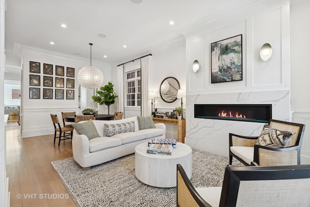 1963 N Dayton St, Chicago, IL 60614 - living room with wood finished floors, a premium fireplace, recessed lighting, ornamental molding, and a decorative wall