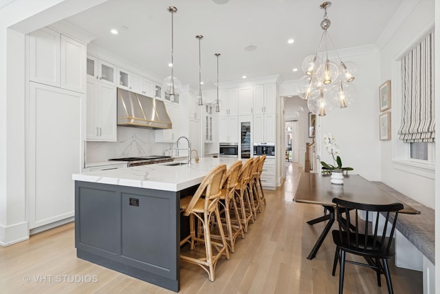 1963 N Dayton St, Chicago, IL 60614 - kitchen with a sink, under cabinet range hood, stainless steel oven, white cabinets, and recessed lighting