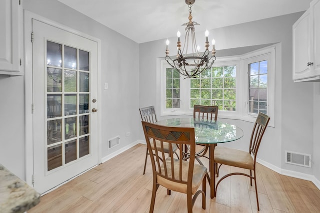 13253 S Oak Ridge Trl Unit 2B, Palos Heights, IL 60463 - dining space featuring a chandelier, light wood-type flooring, and baseboards