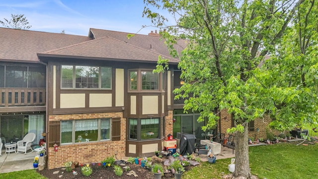 13253 S Oak Ridge Trl Unit 2B, Palos Heights, IL 60463 - rear view of property featuring brick siding, roof with shingles, a patio, stucco siding, and a yard