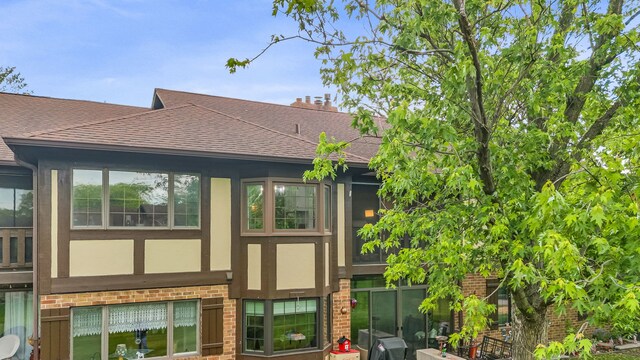 13253 S Oak Ridge Trl Unit 2B, Palos Heights, IL 60463 - back of property featuring a shingled roof, brick siding, and stucco siding