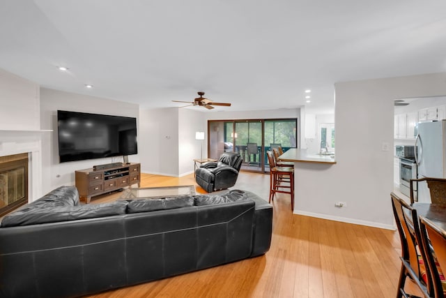 13253 S Oak Ridge Trl Unit 2B, Palos Heights, IL 60463 - living area with baseboards, ceiling fan, light wood-style floors, recessed lighting, and a glass covered fireplace
