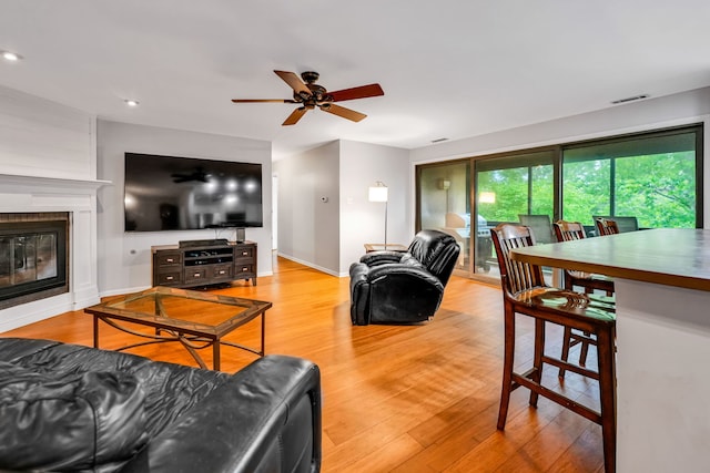13253 S Oak Ridge Trl Unit 2B, Palos Heights, IL 60463 - living area featuring a ceiling fan, wood finished floors, a large fireplace, recessed lighting, and baseboards