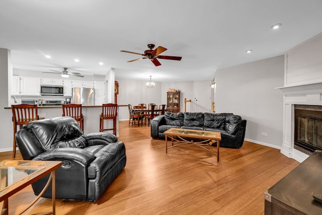 13253 S Oak Ridge Trl Unit 2B, Palos Heights, IL 60463 - living room featuring ceiling fan, light wood-type flooring, a glass covered fireplace, baseboards, and recessed lighting