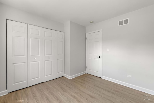 1206 Spur Ct Unit 1206, Wheeling, IL 60090 - unfurnished bedroom featuring light wood-type flooring, baseboards, and a closet