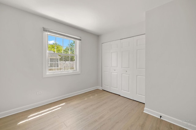 1206 Spur Ct Unit 1206, Wheeling, IL 60090 - unfurnished bedroom with baseboards, wood finished floors, and a closet