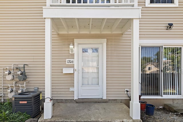 1206 Spur Ct Unit 1206, Wheeling, IL 60090 - view of exterior entry featuring central AC and a balcony