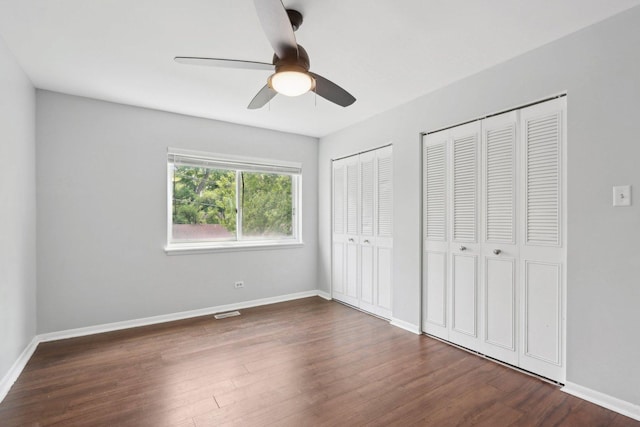 2311 183rd St Unit 203, Homewood, IL 60430 - unfurnished bedroom featuring two closets, wood finished floors, and a ceiling fan
