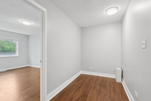 2311 183rd St Unit 203, Homewood, IL 60430 - spare room featuring a textured ceiling and dark wood-style flooring