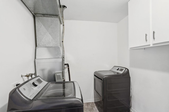 2311 183rd St Unit 203, Homewood, IL 60430 - laundry room featuring independent washer and dryer, cabinet space, and wood finished floors