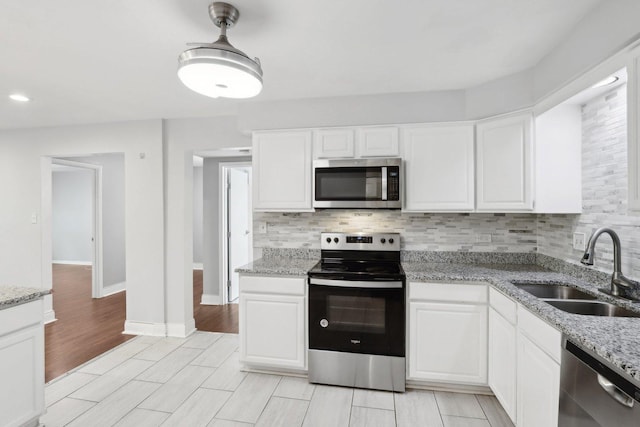 2311 183rd St Unit 203, Homewood, IL 60430 - kitchen with stainless steel appliances, tasteful backsplash, and white cabinetry