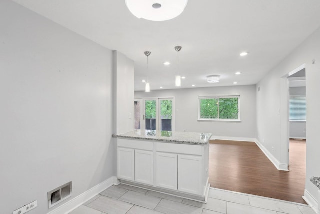 2311 183rd St Unit 203, Homewood, IL 60430 - kitchen featuring a peninsula, light stone countertops, white cabinets, recessed lighting, and pendant lighting