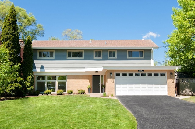 9140 Keystone Ave, Skokie, IL 60076 - view of front of property featuring asphalt driveway, a front lawn, an attached garage, and brick siding