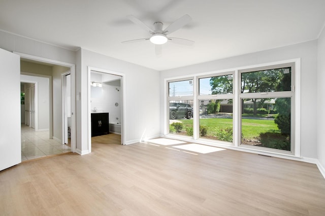9140 Keystone Ave, Skokie, IL 60076 - spare room featuring light wood-style flooring, ceiling fan, and baseboards