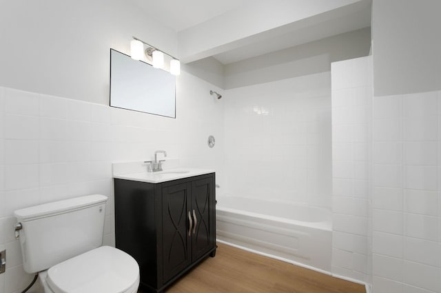 9140 Keystone Ave, Skokie, IL 60076 - full bathroom featuring tile walls, vanity, toilet, wood finished floors, and shower / bathtub combination