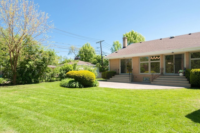 9140 Keystone Ave, Skokie, IL 60076 - view of grassy yard with entry steps and a patio area