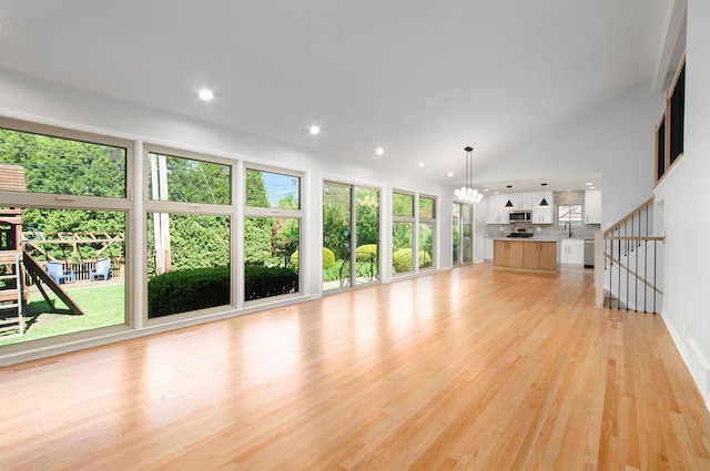 9140 Keystone Ave, Skokie, IL 60076 - unfurnished living room with light wood-style floors, a chandelier, a sink, recessed lighting, and baseboards