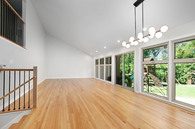 9140 Keystone Ave, Skokie, IL 60076 - spare room featuring plenty of natural light, wood finished floors, lofted ceiling, recessed lighting, and a chandelier