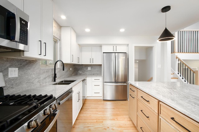 9140 Keystone Ave, Skokie, IL 60076 - kitchen with stainless steel appliances, a sink, light wood finished floors, decorative light fixtures, and backsplash