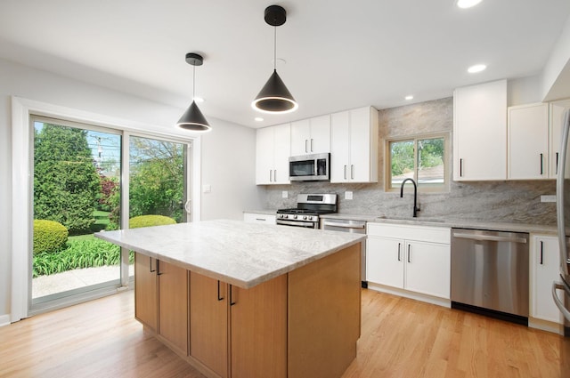 9140 Keystone Ave, Skokie, IL 60076 - kitchen with stainless steel appliances, a sink, decorative backsplash, light wood finished floors, and recessed lighting