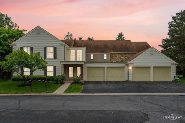 312 Dunham Place Commons Unit 312, Saint Charles, IL 60174 - view of front of home with driveway, a garage, and a yard
