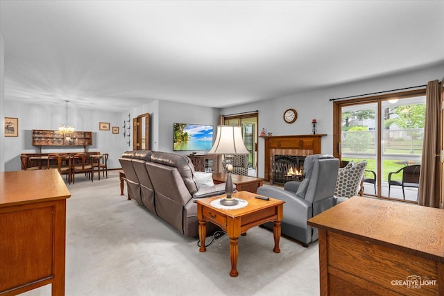 312 Dunham Place Commons Unit 312, Saint Charles, IL 60174 - living area with light carpet, a fireplace, and a chandelier