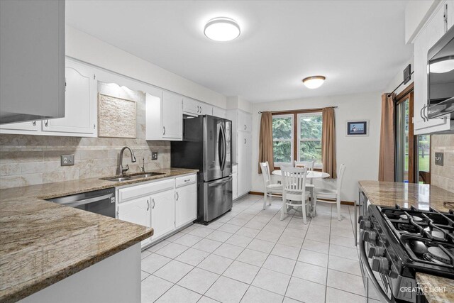 312 Dunham Place Commons Unit 312, Saint Charles, IL 60174 - kitchen featuring a sink, stainless steel appliances, decorative backsplash, white cabinets, and light tile patterned floors