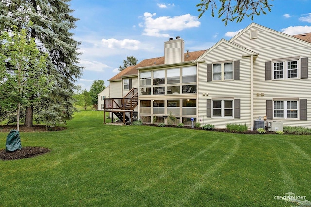 312 Dunham Place Commons Unit 312, Saint Charles, IL 60174 - rear view of property with a chimney, a lawn, and cooling unit