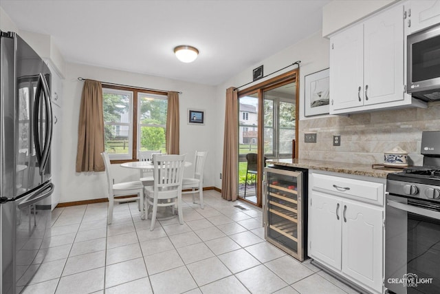312 Dunham Place Commons Unit 312, Saint Charles, IL 60174 - kitchen featuring beverage cooler, stainless steel appliances, healthy amount of natural light, and white cabinetry