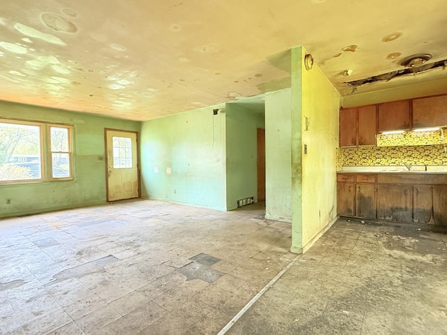 2804 Old Oak Dr, Mchenry, IL 60050 - kitchen featuring brown cabinets, open floor plan, backsplash, and a sink