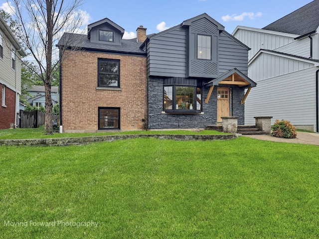 611 S Fern Ave, Elmhurst, IL 60126 - view of front of house with a front lawn, stone siding, and a chimney