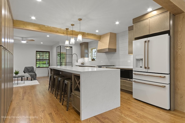 611 S Fern Ave, Elmhurst, IL 60126 - kitchen with high end white fridge, wall chimney range hood, light wood-type flooring, backsplash, and beam ceiling