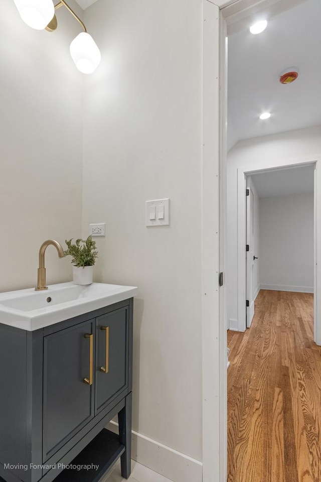 611 S Fern Ave, Elmhurst, IL 60126 - bathroom with baseboards, wood finished floors, and vanity