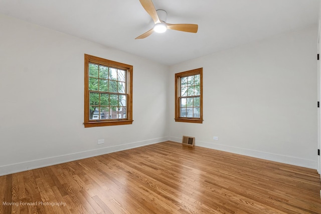 611 S Fern Ave, Elmhurst, IL 60126 - empty room featuring light wood-style flooring, a ceiling fan, and baseboards