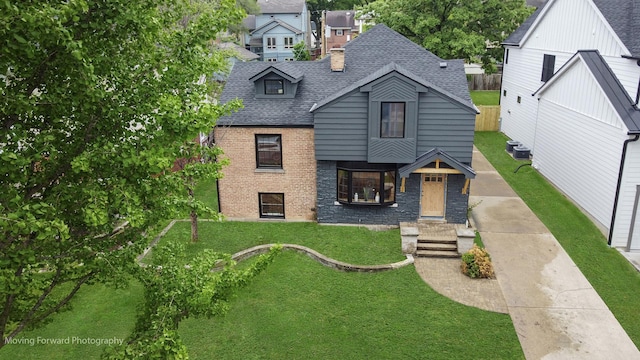 611 S Fern Ave, Elmhurst, IL 60126 - view of front of home featuring roof with shingles, a front yard, and brick siding