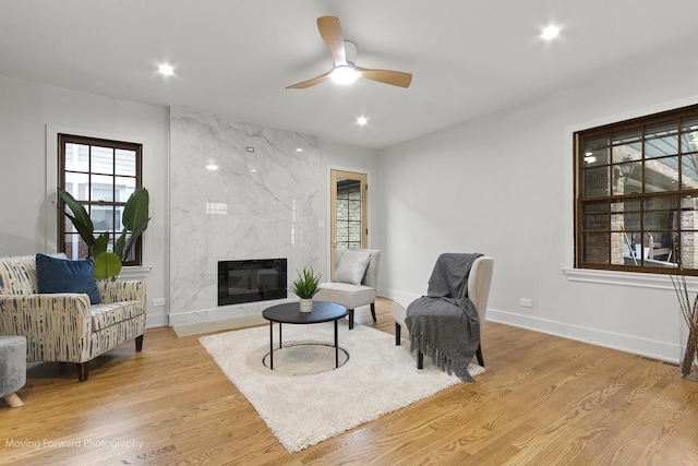 611 S Fern Ave, Elmhurst, IL 60126 - sitting room featuring baseboards, a high end fireplace, light wood-type flooring, recessed lighting, and ceiling fan