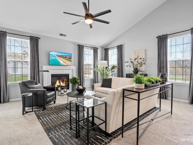 1022 Broadmoor Dr, Elgin, IL 60124 - carpeted living area featuring baseboards, ceiling fan, a glass covered fireplace, and vaulted ceiling