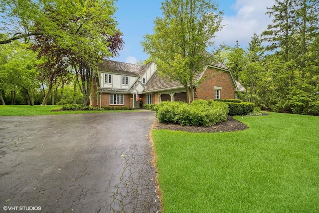 706 Tanglewood Ct, Lake Forest, IL 60045 - view of front of property featuring asphalt driveway, a garage, a front yard, and brick siding