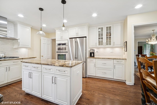 706 Tanglewood Ct, Lake Forest, IL 60045 - kitchen featuring appliances with stainless steel finishes, tasteful backsplash, wall chimney exhaust hood, glass insert cabinets, and recessed lighting