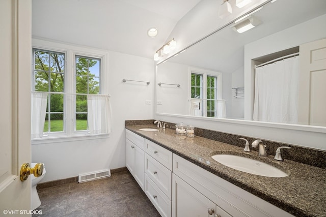 706 Tanglewood Ct, Lake Forest, IL 60045 - bathroom with lofted ceiling, double vanity, baseboards, and toilet