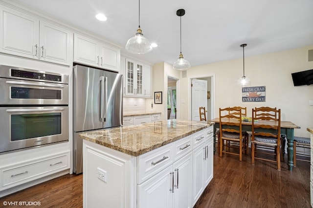 706 Tanglewood Ct, Lake Forest, IL 60045 - kitchen featuring stainless steel appliances, dark wood-style floors, decorative backsplash, white cabinetry, and light stone counters