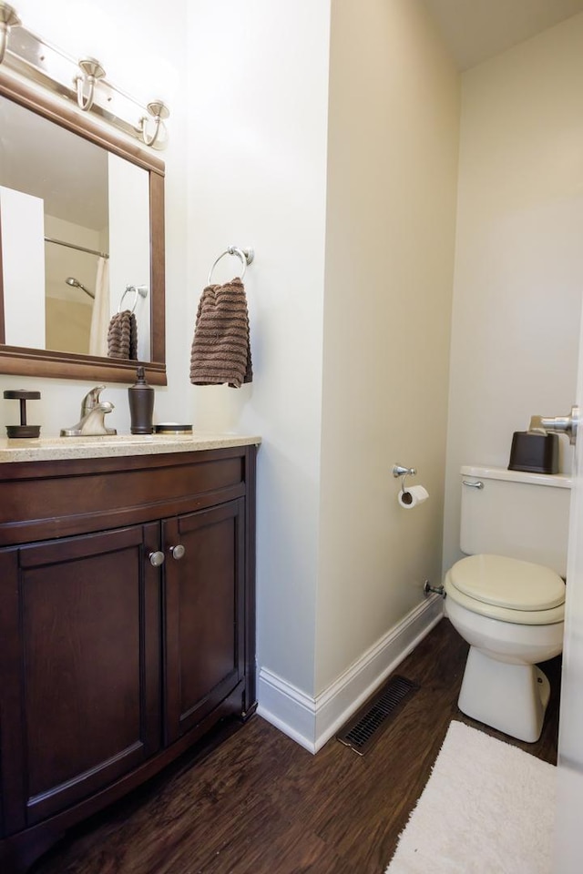 358 Princeton Ave, Bourbonnais, IL 60914 - bathroom with wood finished floors, toilet, baseboards, vanity, and curtained shower