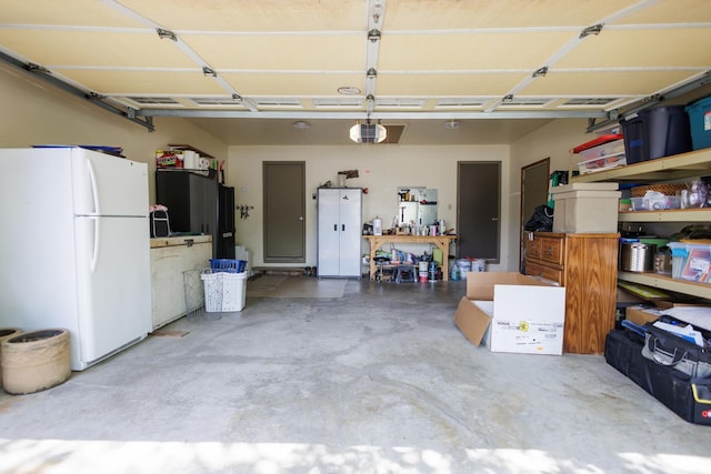 358 Princeton Ave, Bourbonnais, IL 60914 - garage featuring freestanding refrigerator and a garage door opener