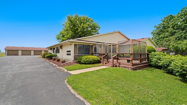 701 W Oregon St, Polo, IL 61064 - view of front facade featuring a wooden deck, a front lawn, and a garage